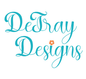 DeTray Designs in a blue cursive script with an orange flower dotting the I